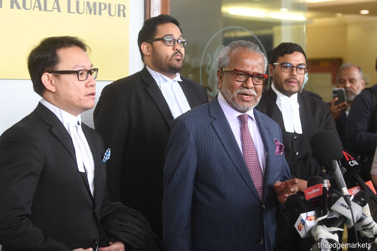 Lead defence counsel Tan Sri Muhammad Shafee Abdullah (centre) says that he hopes the Attorney General's Chambers will not appeal against the decision. (Photo by Patrick Goh/The Edge)